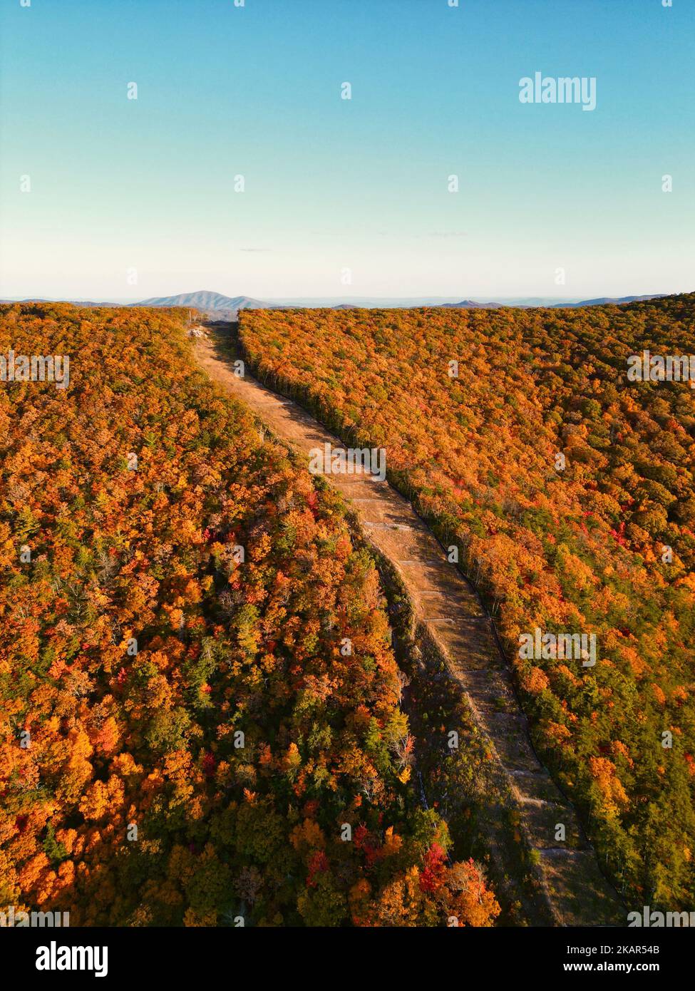 An aerial drone view of beautiful mountains and colorful trees on a ...