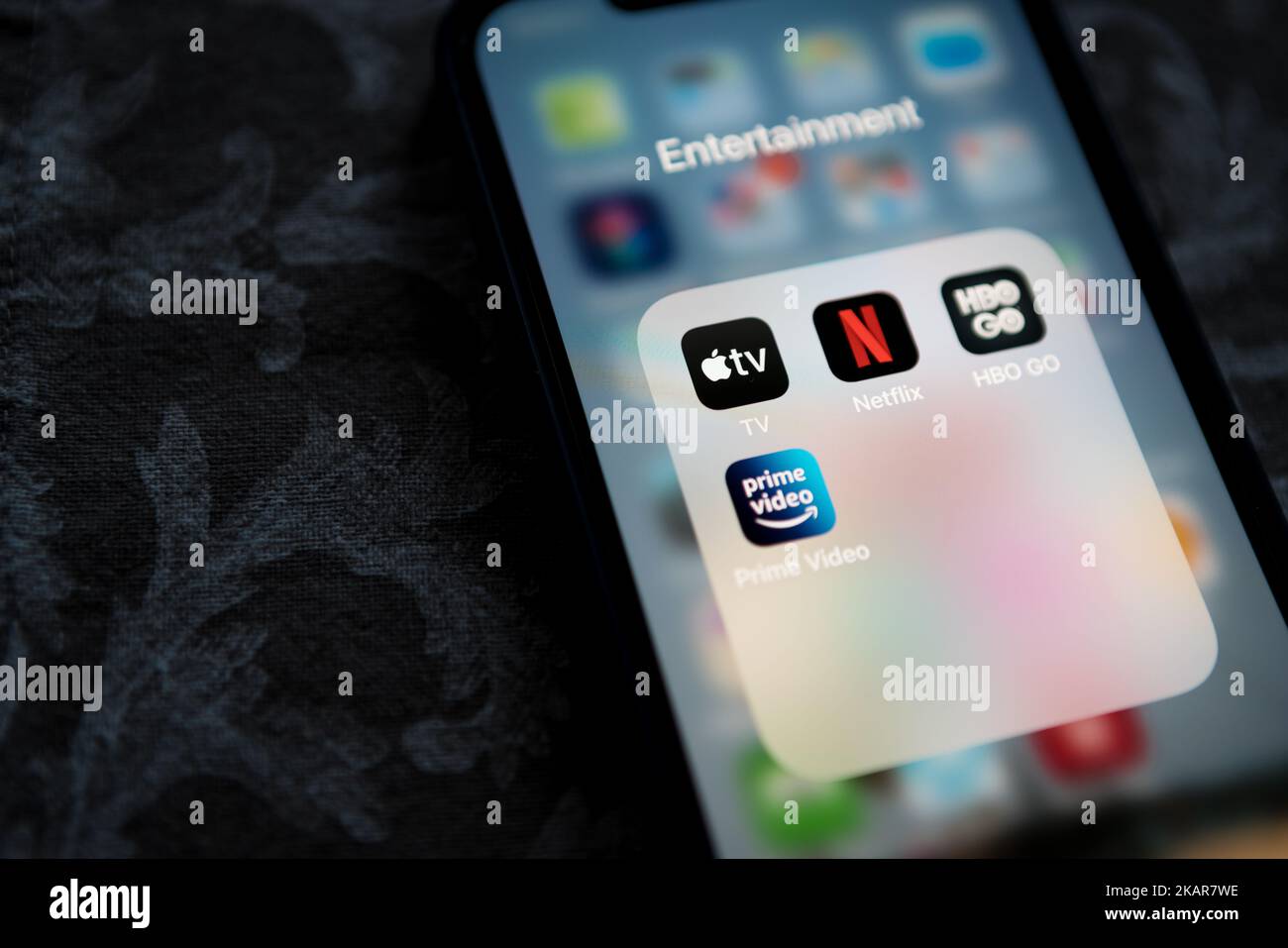 Krakow, Poland - July 14, 2021: Apple TV+ application icon among Netflix, Amazon Prime Video, and HBO GO in Entertainment Folder on Apple iPhone 12 Pr Stock Photo