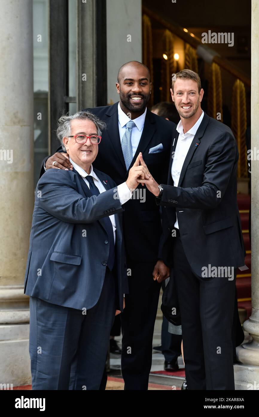 Teddy Riner (C) and Aalain Bernard (R) leave the Elysee Palace in Paris after a ceremony to