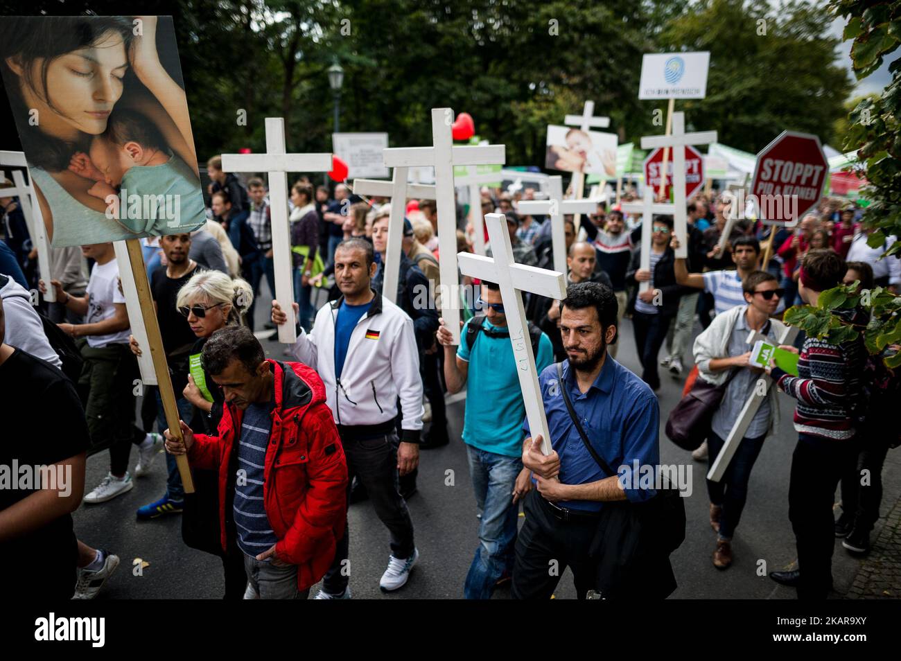 A participant of the demonstration 'Marsch fuer das Leben' (lit. march for life) holds a white cross on the meadow in front of the Reichstag building in Berlin, Germany, 16 September 2017. (Photo by Markus Heine/NurPhoto) Stock Photo