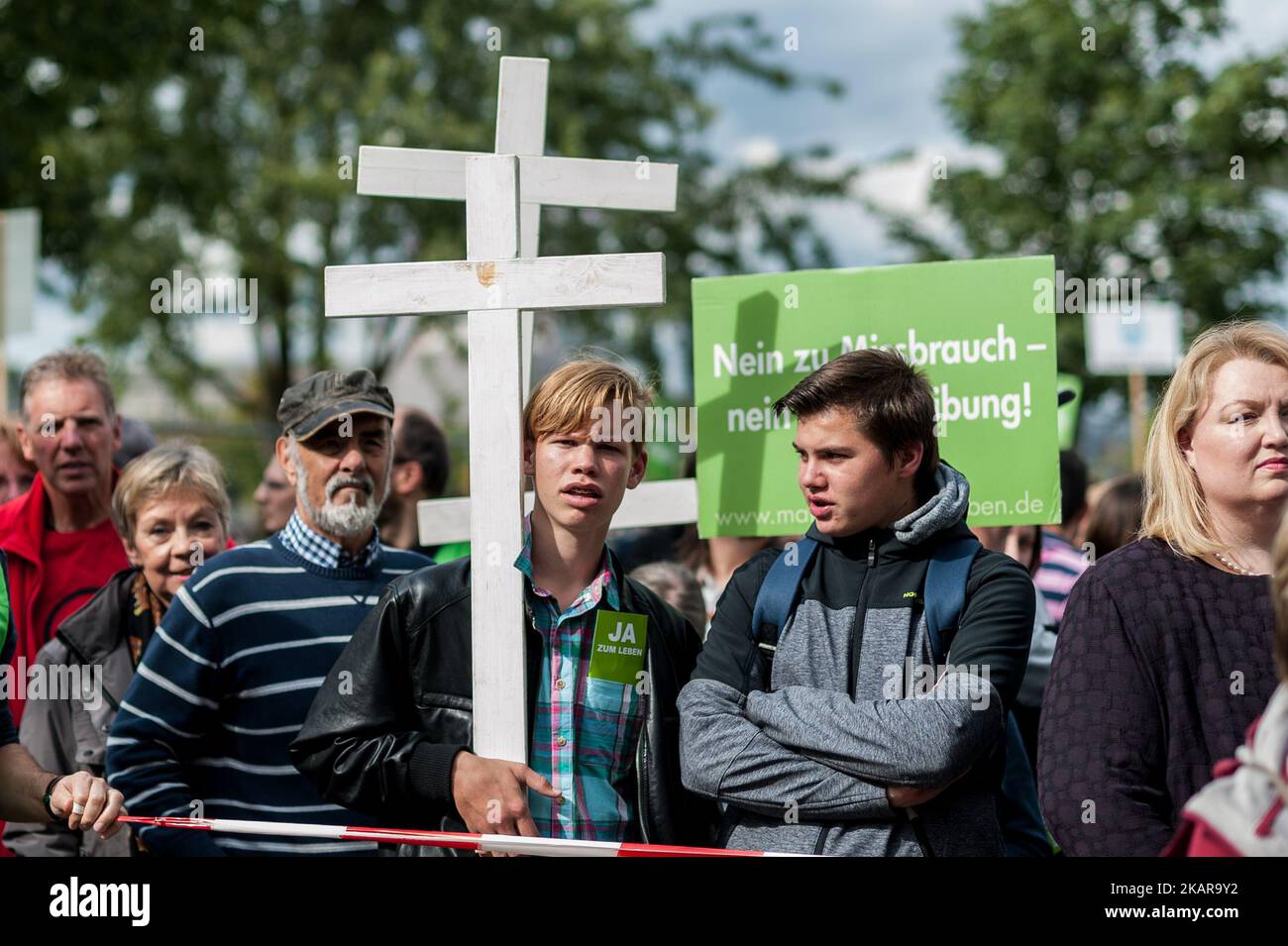 A participant of the demonstration 'Marsch fuer das Leben' (lit. march for life) holds a white cross on the meadow in front of the Reichstag building in Berlin, Germany, 16 September 2017. (Photo by Markus Heine/NurPhoto) Stock Photo