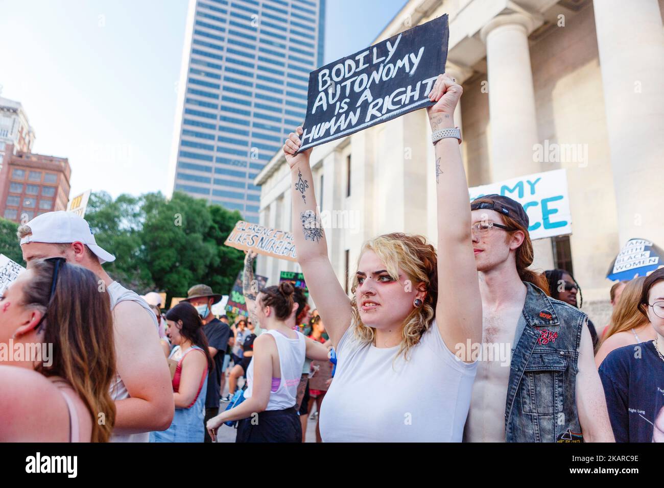An angry woman holds a protest sign aloft at pro-choice rally Stock Photo