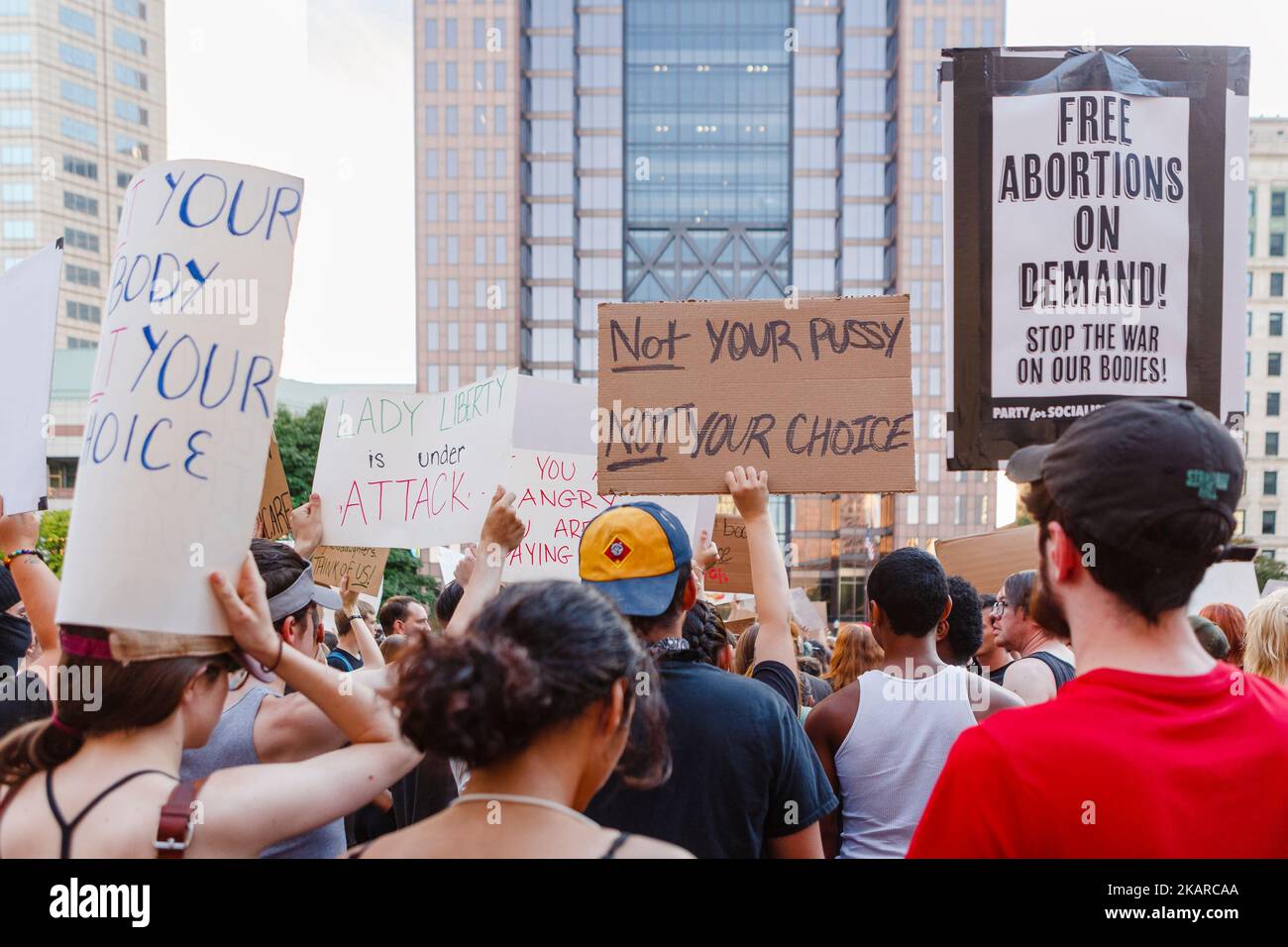 Protesters hold pro-choice signs above heads at abortion rally Stock Photo