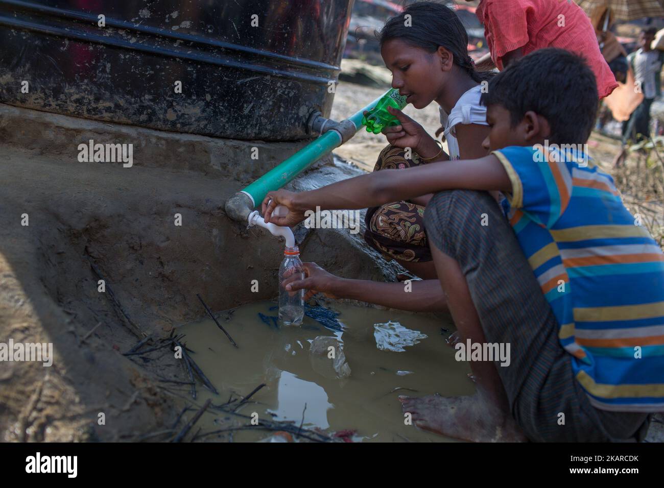Rohingya refugee kids are trying to collect drinking water. Balikhali ...