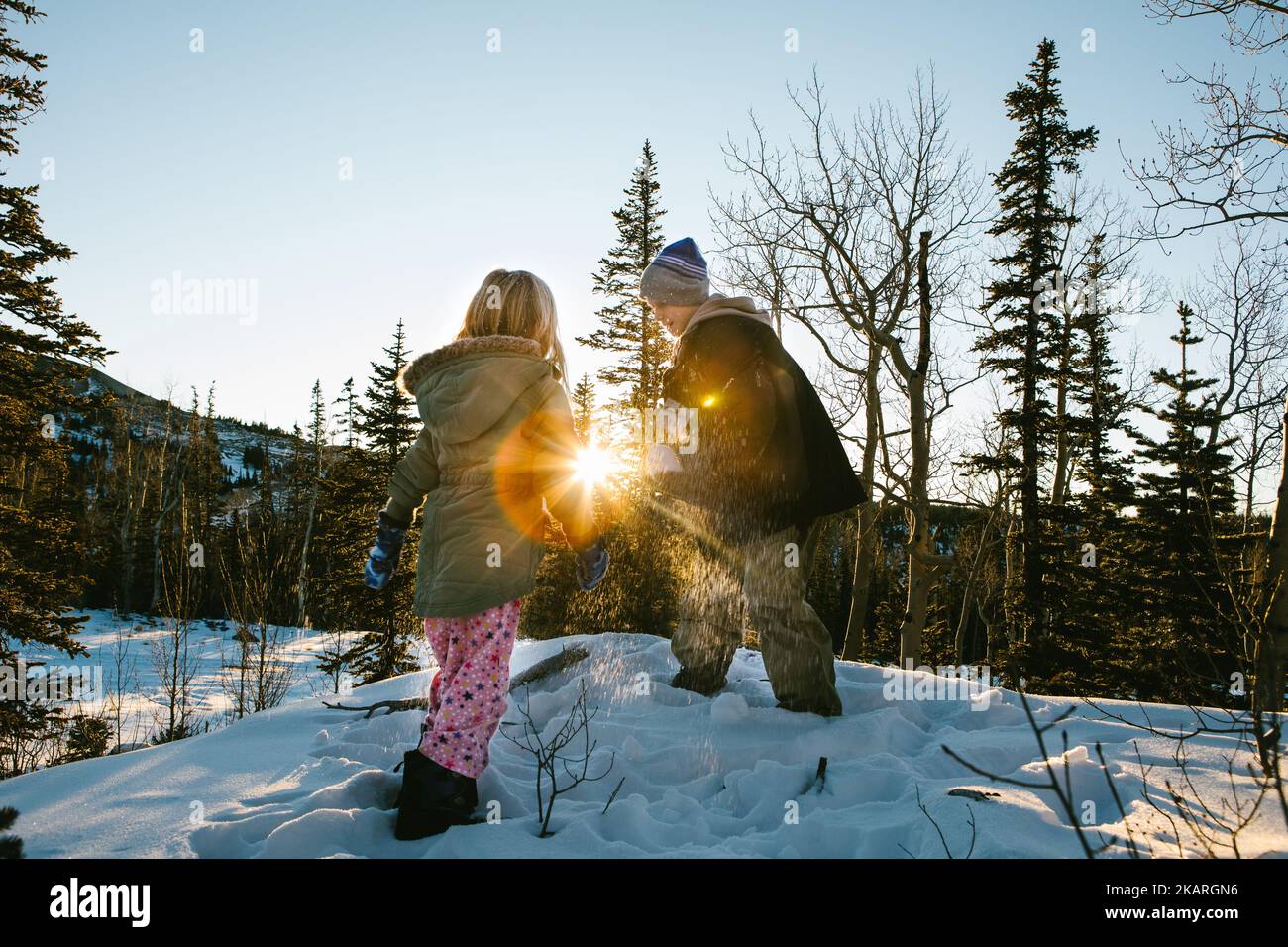 Brother and sister play in the snow in a forest Stock Photo - Alamy