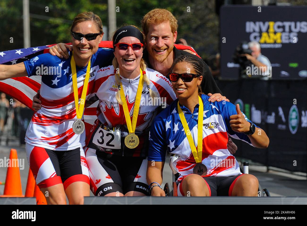 Prince Harry poses with medalists in the Women's Recumbent Bike IRECB1 time trial, (L-R) silver medalist Amy Dotson of the United States, gold medalist Julie Marcotte of Canada and bronze medalist Gabby Graves-Wake of the United States at the cycling time trial at the Invictus Games in High Park in Toronto, Ontario, September 26, 2017. The first Invictus Games, based on the Paralympic Games, were held in September 2014 in London. They were launched by Prince Harry, who served with the British Army in Afghanistan. (Photo by Anatoliy Cherkasov/NurPhoto) Stock Photo