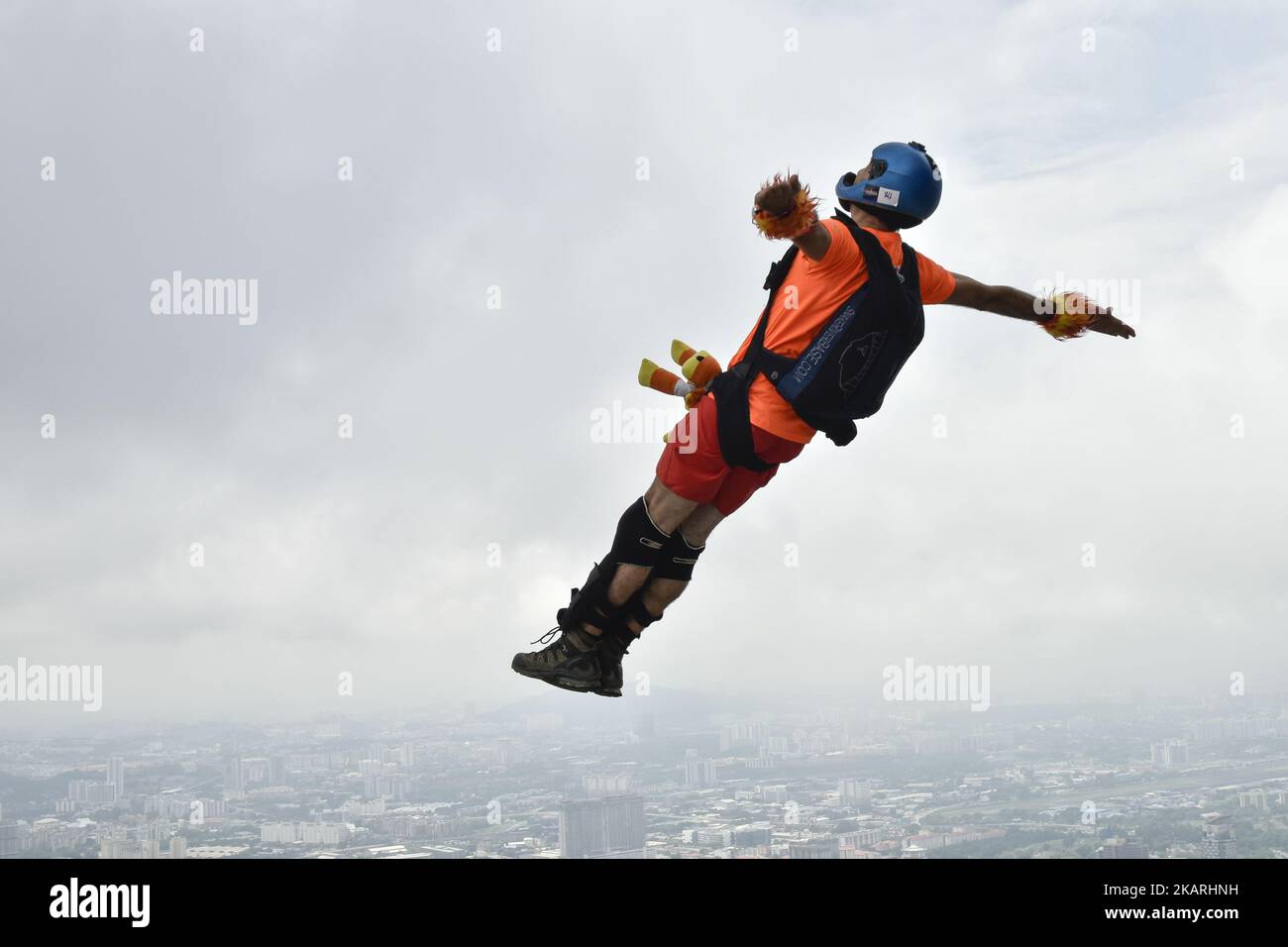 Base jumpers leaps from the 300 meter high open deck at Kuala Lumpur