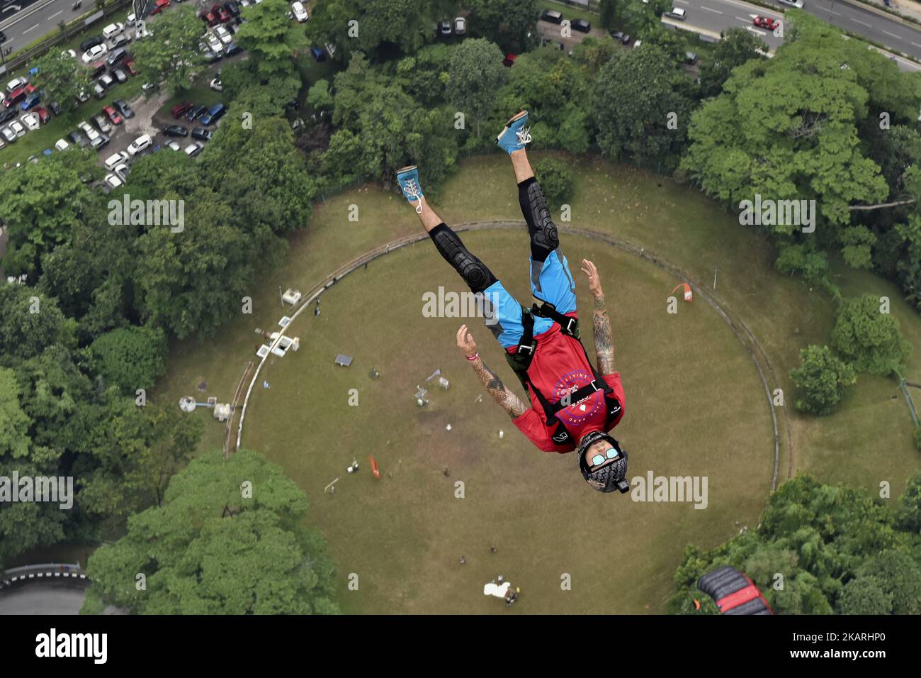 Base jumpers leaps from the 300 meter high open deck at Kuala Lumpur