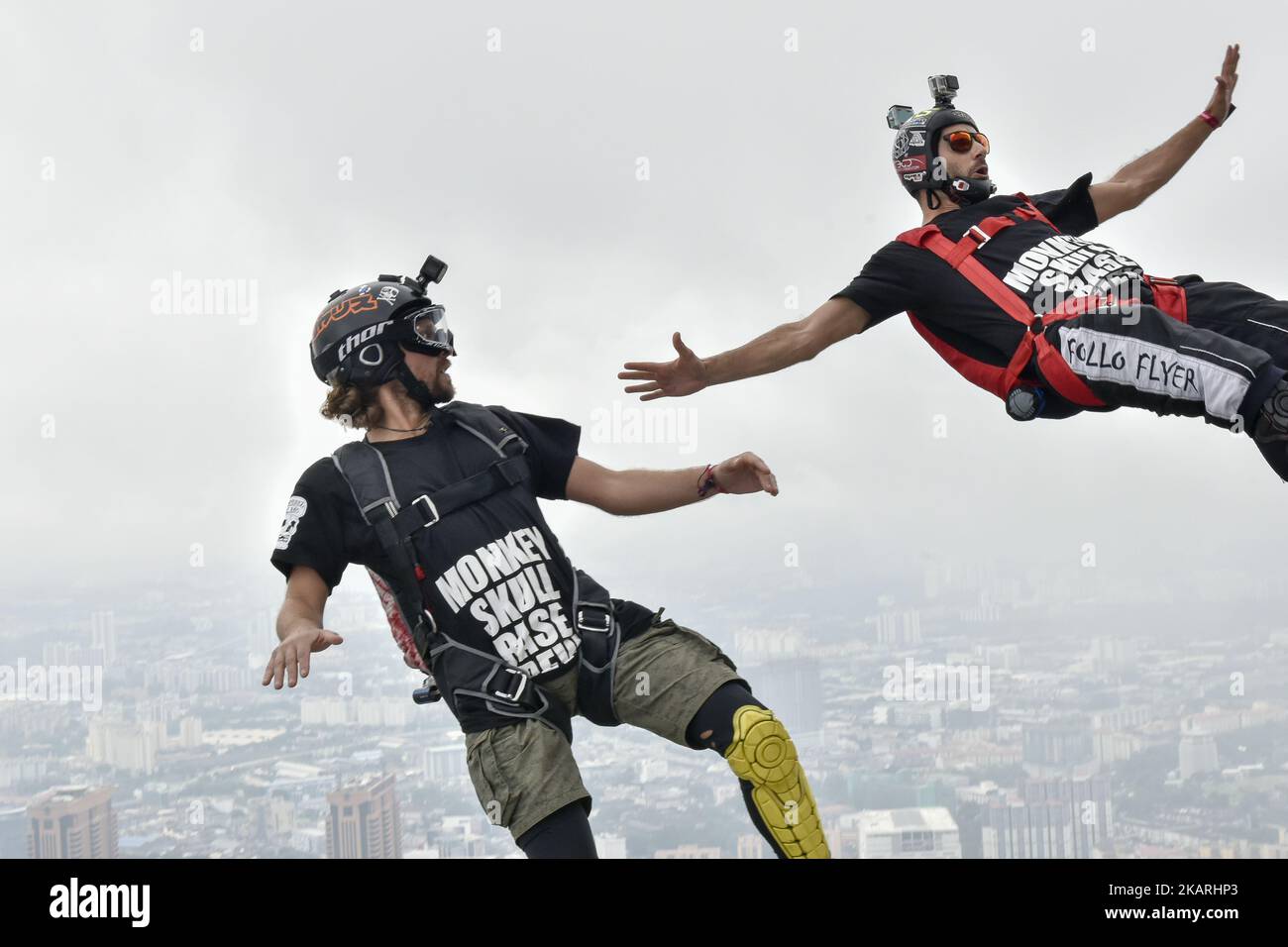 Base jumpers leaps from the 300 meter high open deck at Kuala Lumpur
