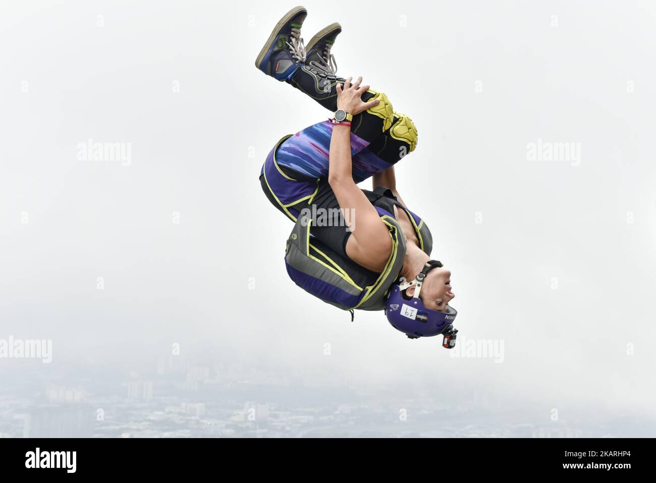 Base jumpers leaps from the 300 meter high open deck at Kuala Lumpur