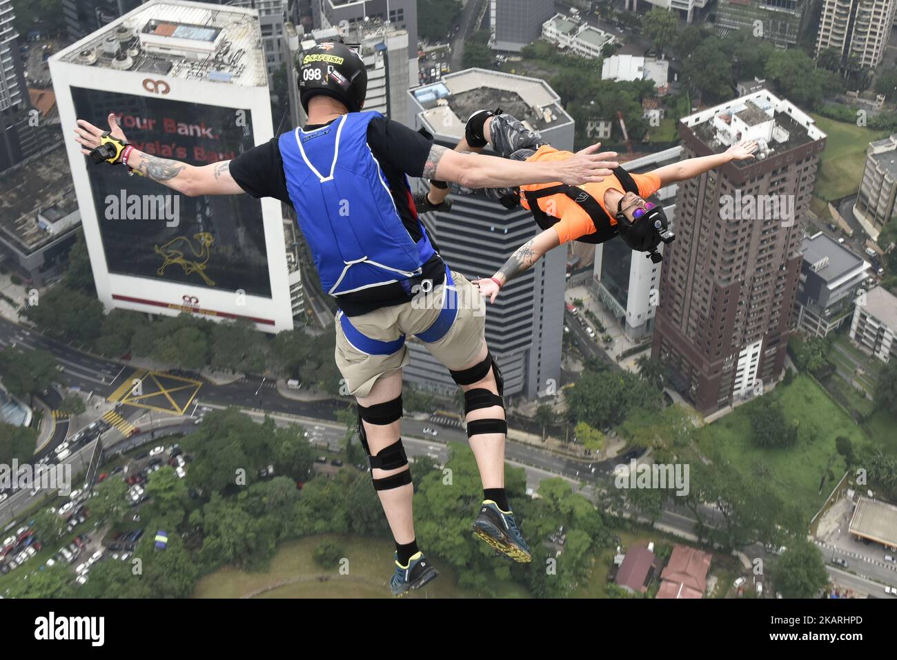 Base jumpers leaps from the 300 meter high open deck at Kuala Lumpur