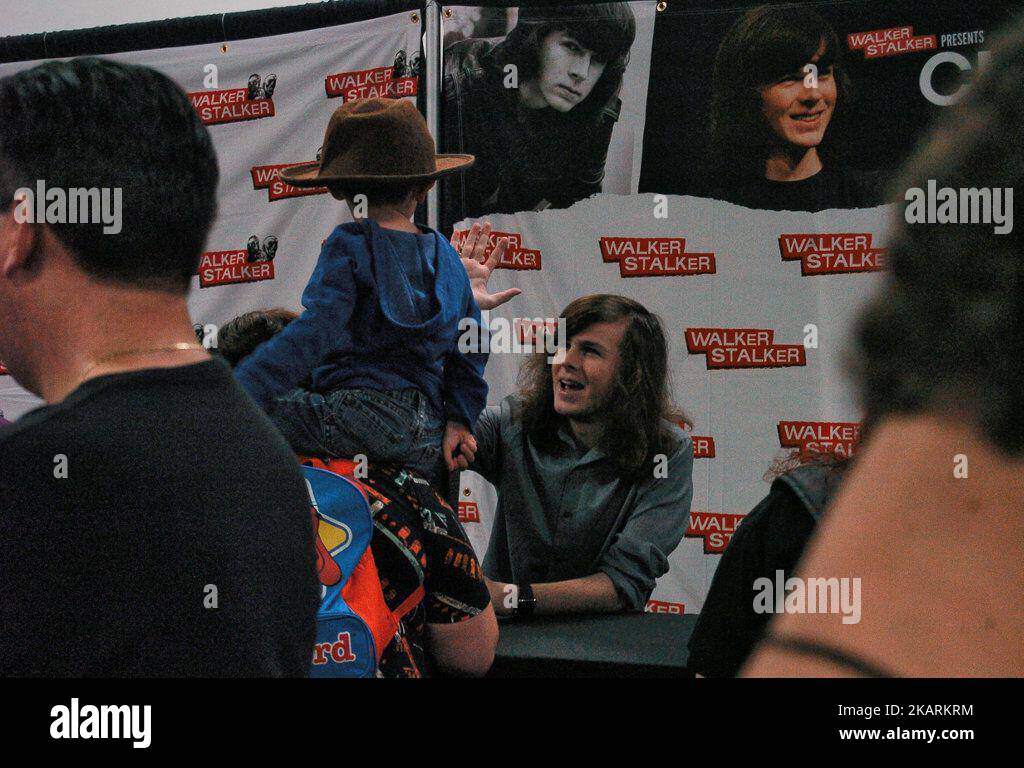 Chandler Riggs gives a young fan a high five Tom Payne shows love for ...