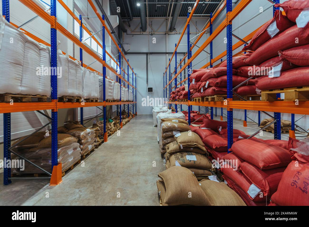 Bags with production on shelves in warehouse. Bags with coffee beans or
