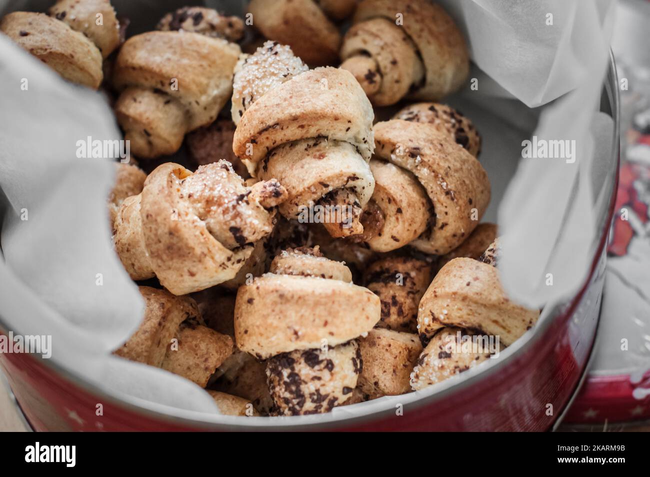 Mini croissants with chocolate chips in a red round tin container Stock ...