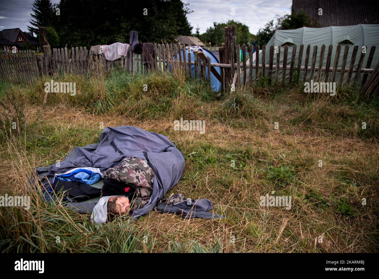 Woman sleeps near Camp for Forest becouse lack of free space inside. 'Camp for Forest' Pogorzelce near Bialowieza on August 15, 2017 (Photo by Maciej Luczniewski/NurPhoto) Stock Photo