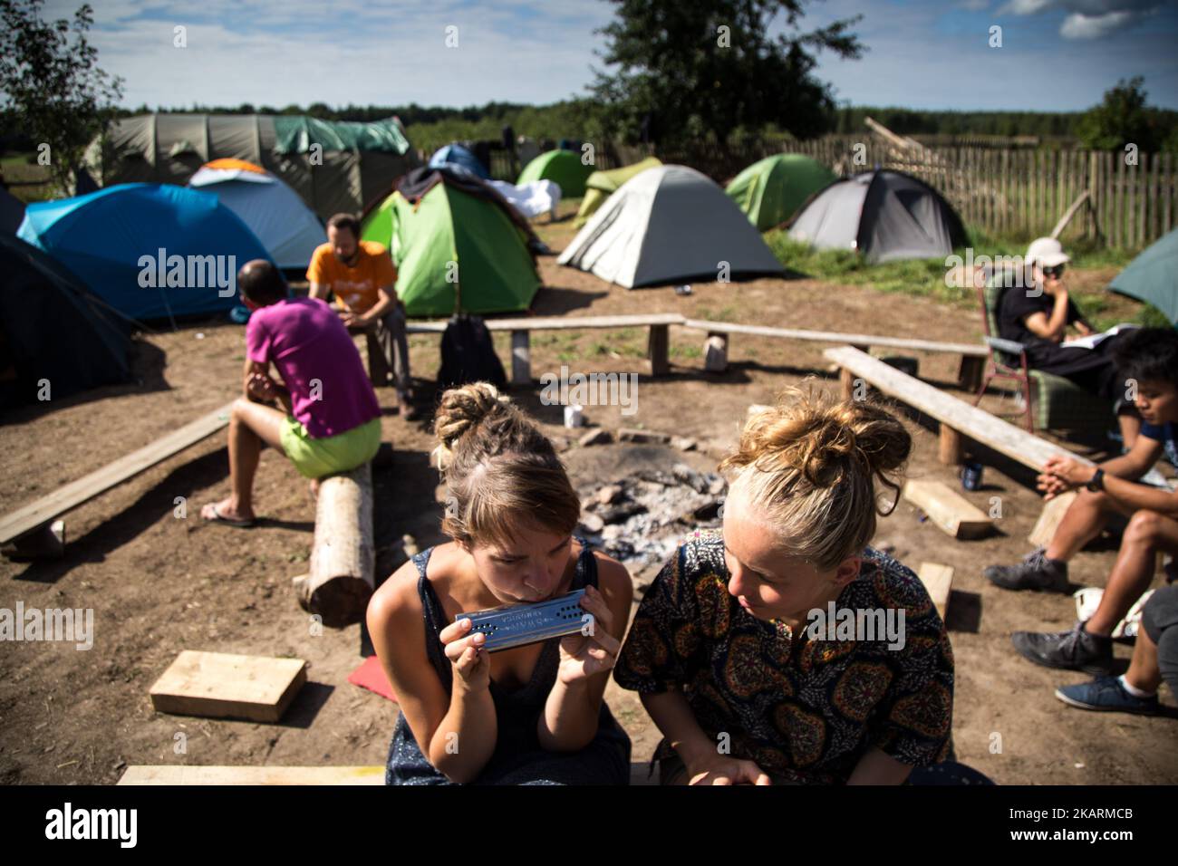 Woman plays on harmonica. 'Camp for Forest' Pogorzelce near Bialowieza on August 15, 2017. (Photo by Maciej Luczniewski/NurPhoto) Stock Photo