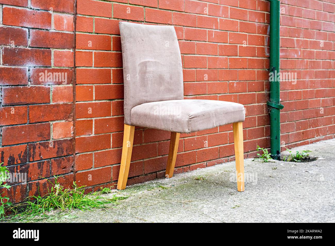 Dining room chair with broken leg abandoned in a street Stock Photo Alamy