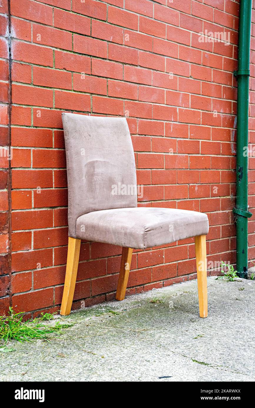 Dining room chair with broken leg abandoned in a street Stock Photo Alamy