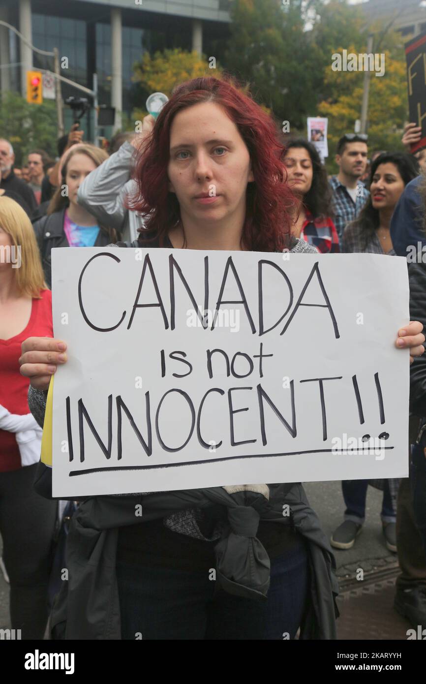 Protestor holds a sign saying 'Canada is not Innocent' during a rally against White Supremacy and Islamophobia at Queen's Park in Toronto, Ontario, Canada, on October 15, 2017. (Photo by Creative Touch Imaging Ltd./NurPhoto) Stock Photo