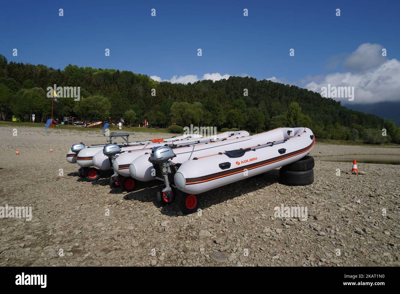 Three rubber dinghy or boats with overboard suspended motor laying on
