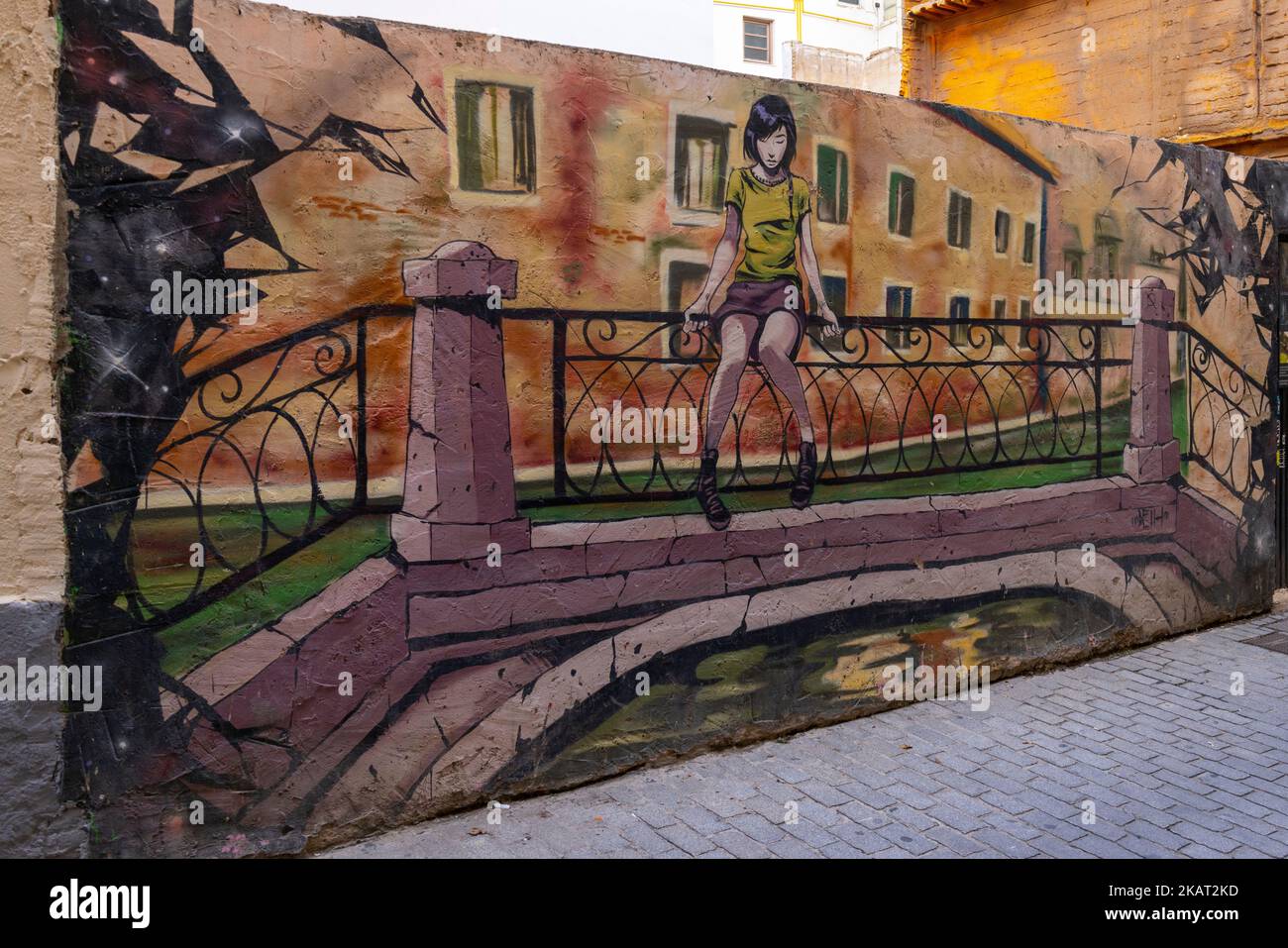 Illustration of girl sat on fence on bridge on wall, Carrer de Moret, Valencia, Spain Stock Photo
