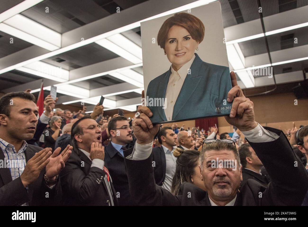 A Crowd Cheers While A Man Holds Up A Portrait Of Meral Ak?ener, A ...