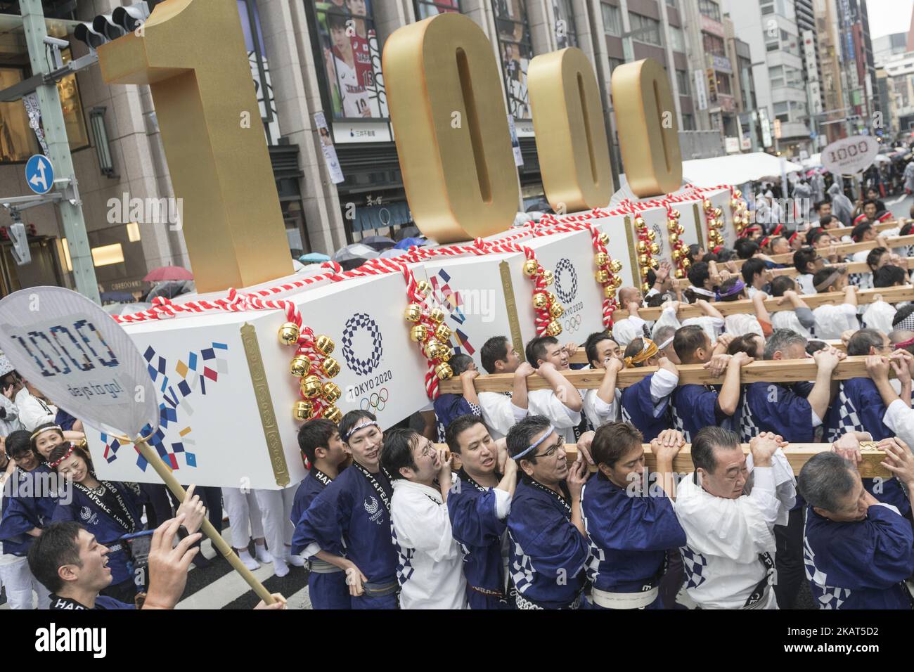 Participants carry portable floats featuring number of 1,000 as they attend the countdown ceremony to mark 1,000 days until the 2020 Tokyo Olympic Games in Tokyo, Japan October 28, 2017.Â (Photo by Alessandro Di Ciommo/NurPhoto) Stock Photo