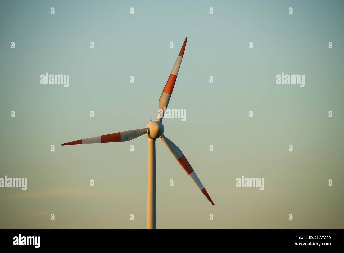 A wind turbine against a blue sky Stock Photo - Alamy