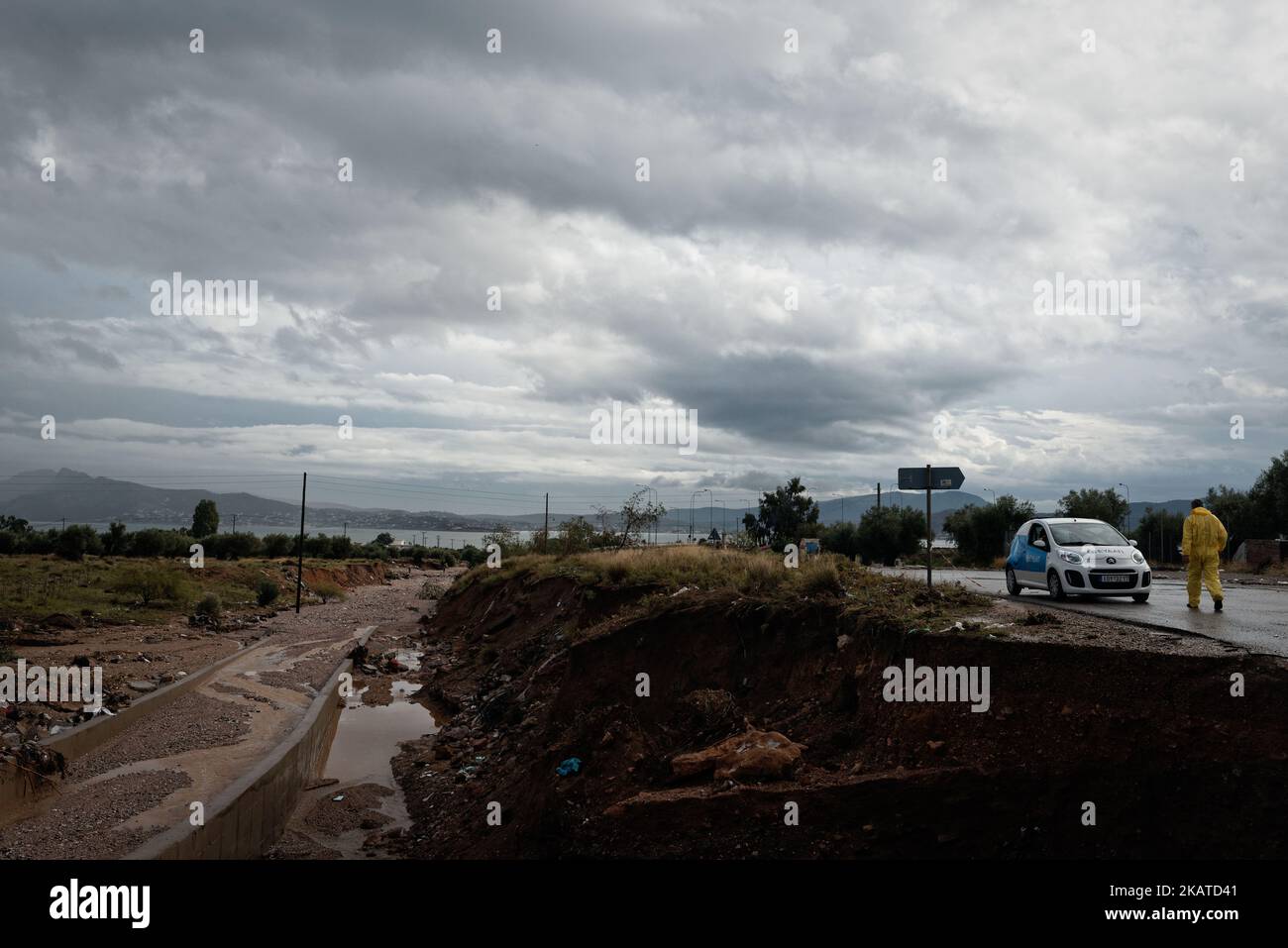 Damages caused by floods are seen on the road near Nea Peramos, Greece on November 17, 2017. Flash floods have killed 16 people causing 'biblical damage' as fast-flowing torrents of red mud flooded roads in the western outskirts of the Greek capital, Athens. (Photo by Gerasimos Koilakos/NurPhoto) Stock Photo