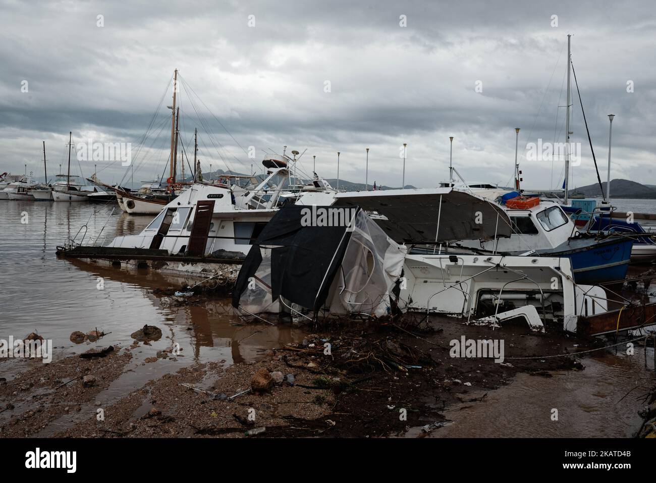 Damages caused by floods are seen at the harbour of Nea Peramos, Greece on November 17, 2017. Flash floods have killed 16 people causing 'biblical damage' as fast-flowing torrents of red mud flooded roads in the western outskirts of the Greek capital, Athens. (Photo by Gerasimos Koilakos/NurPhoto) Stock Photo