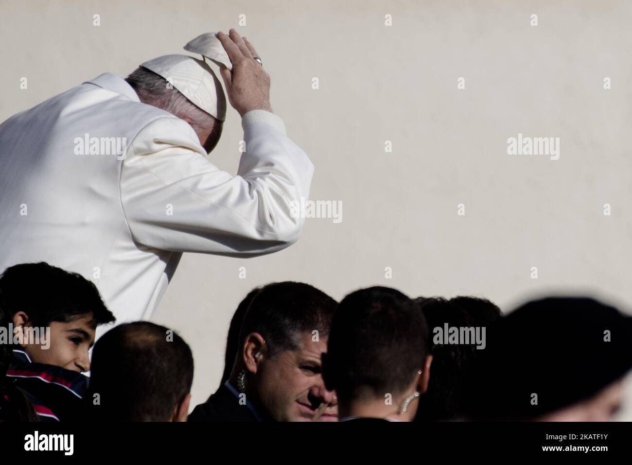 Pope Francis changes his zucchetto (skullcap) as he leaves St. Peter's Square in Vatican city for his weekly general audience, Wednesday, Nov. 22, 2017. (Photo by Massimo Valicchia/NurPhoto) Stock Photo