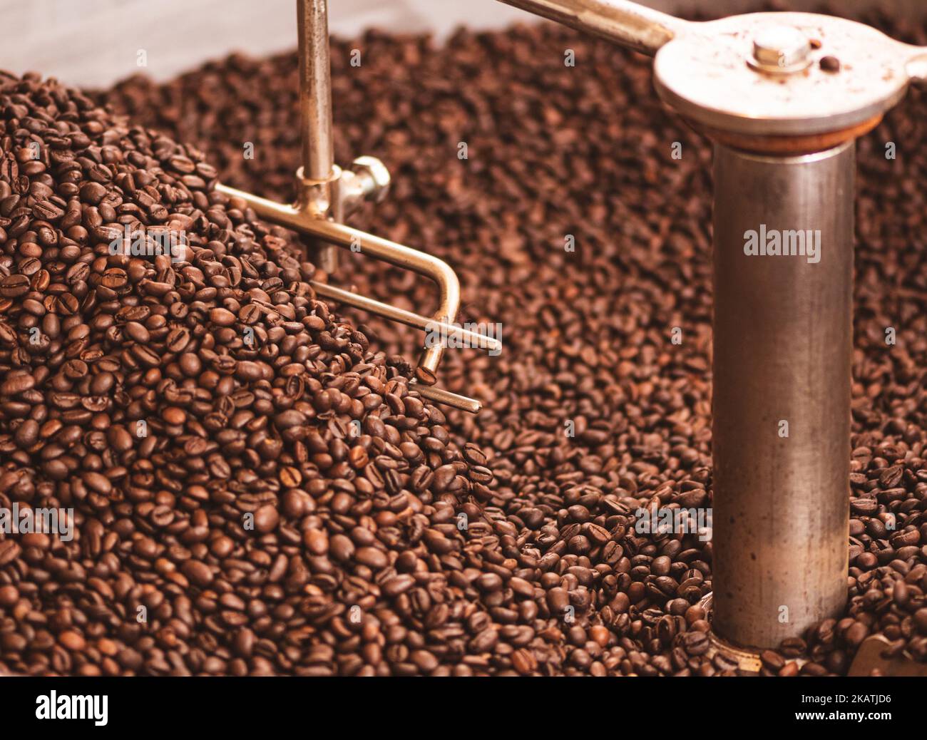 Roasting coffee beans in a professional old coffee roasting machine or