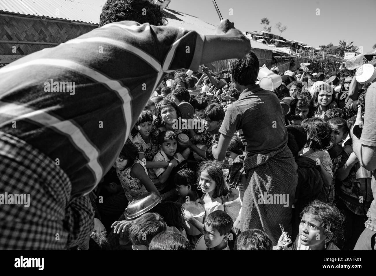 Rohingya refugee children struggle as they wait to receive food outside a distribution point of the Turkish aid organization TIKA at the Jamtoli refugee camp near Cox's Bazar, Bangladesh, December 01, 2017. (Photo by Szymon Barylski/NurPhoto) Stock Photo