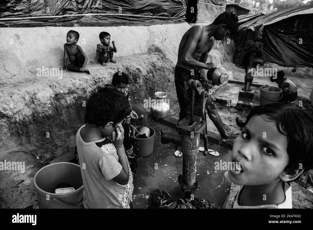 A Rohingya refugee washes at a well at the Balukhali refugee camp near Cox's Bazar, Bangladesh, November 30, 2017. (Photo by Szymon Barylski/NurPhoto) Stock Photo