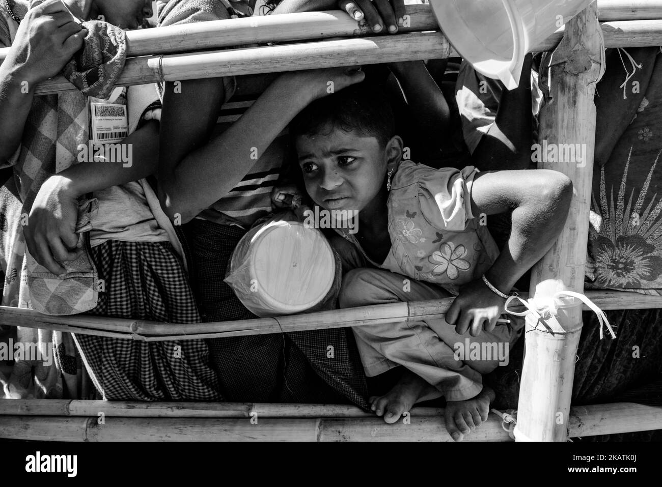 Rohingya refugee children struggle as they wait to receive food outside a distribution point of the Turkish aid organization TIKA at the Jamtoli refugee camp near Cox's Bazar, Bangladesh, December 01, 2017. (Photo by Szymon Barylski/NurPhoto) Stock Photo
