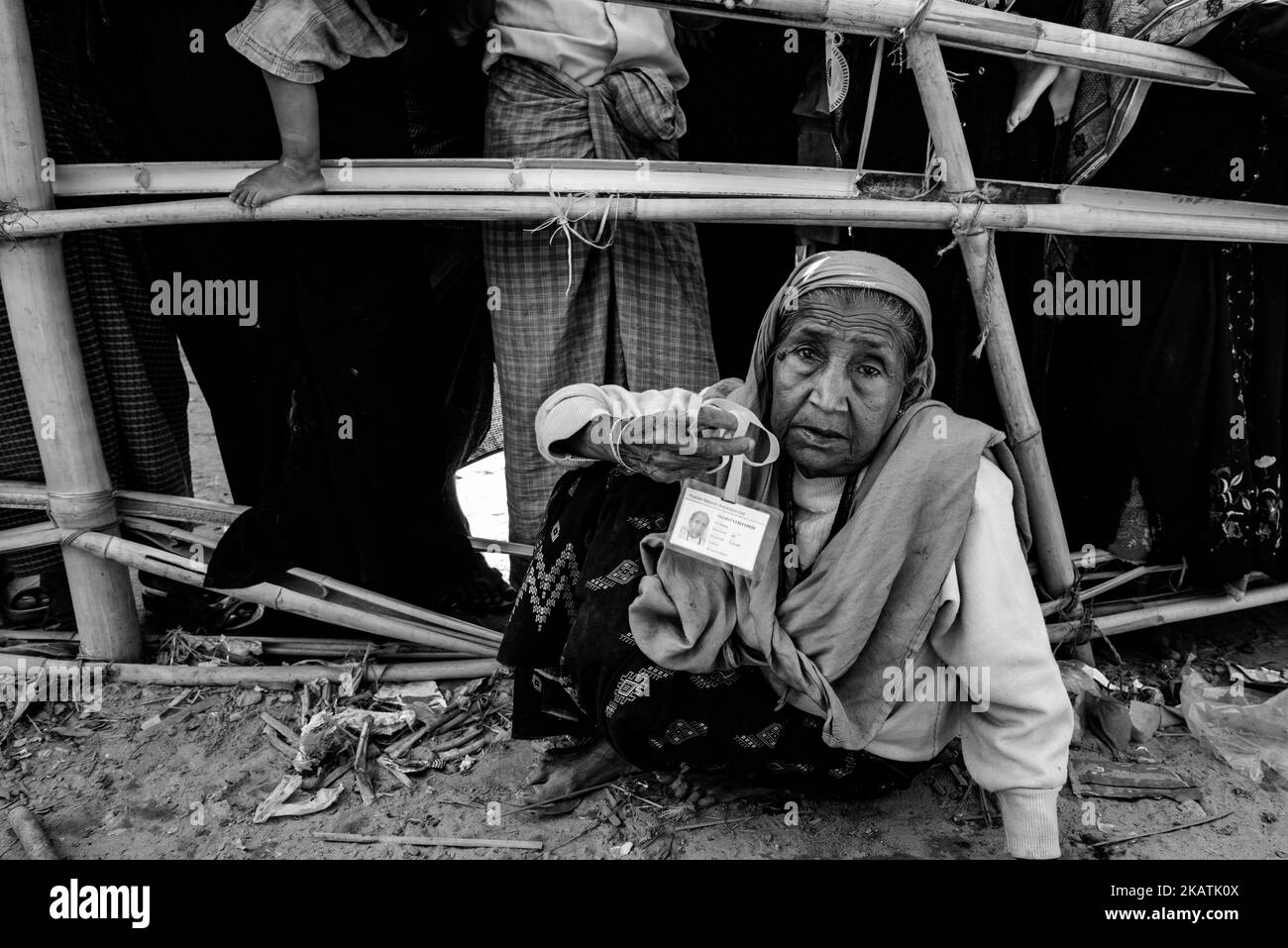 A Rohingya refugee old whoman waits to receive food aid from a local NGO at the Balukhali refugee camp near Cox's Bazar, Bangladesh, November 30, 2017. (Photo by Szymon Barylski/NurPhoto) Stock Photo