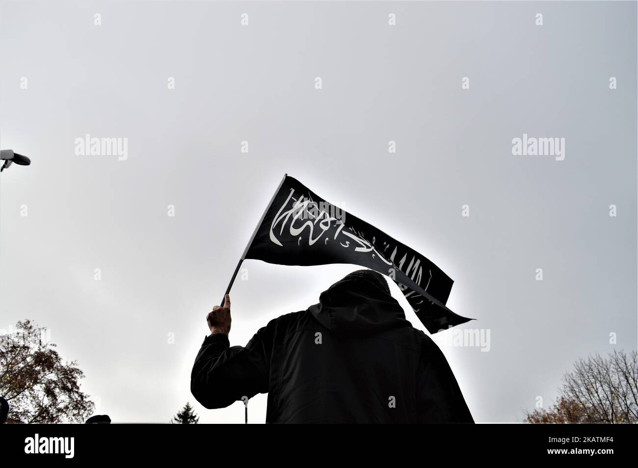 A photo taken in Ankara, Turkey on December 7, 2017 shows a protester waving a black flag with Arabic letters as Turkish Muslims take part in a protest near the U.S. Embassy against its president Donald Trump's officially recognition the city of Jerusalem as the capital of Israel on December 6. (Photo by Altan Gocher/NurPhoto) Stock Photo