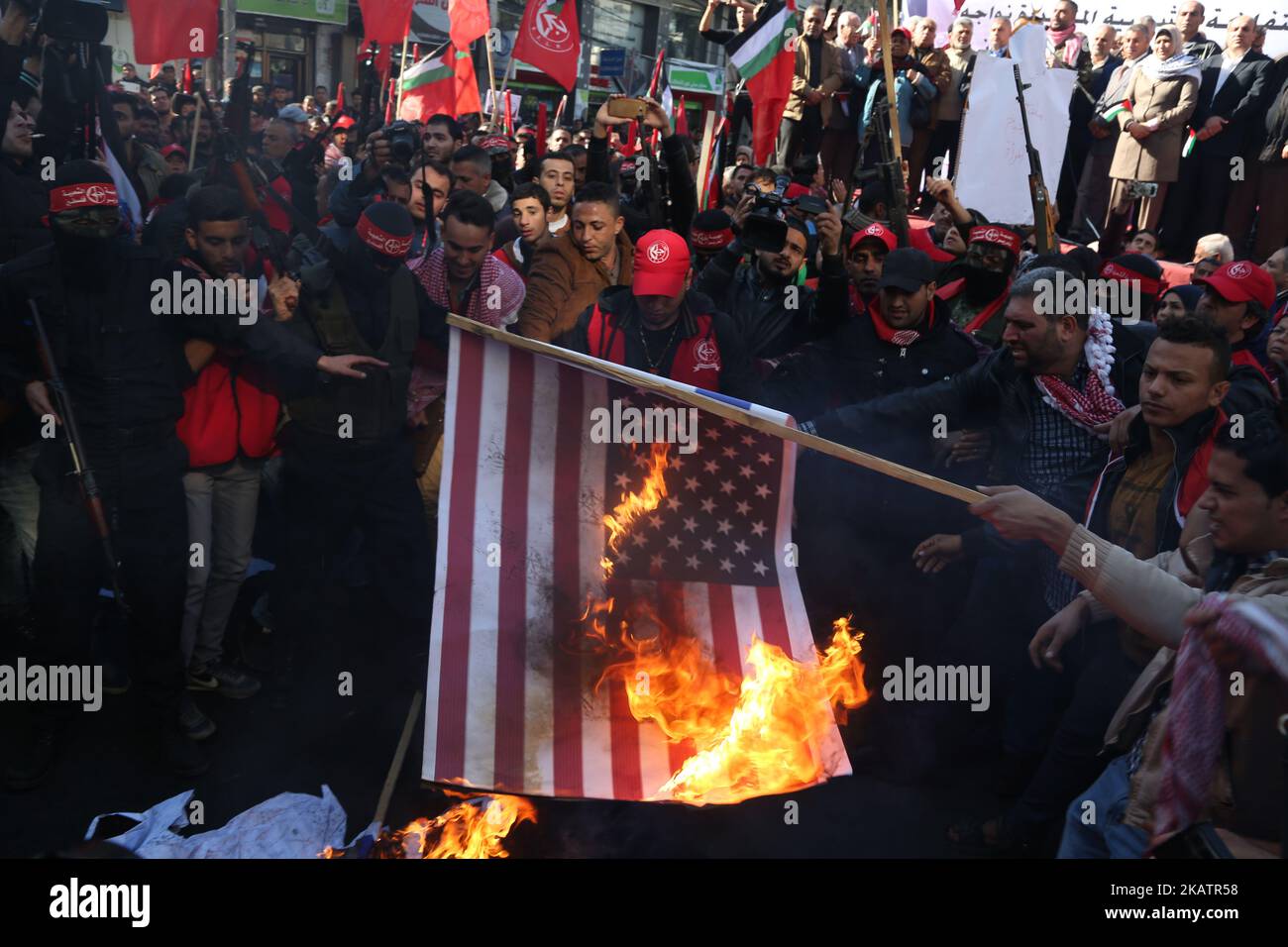 Palestinian militants of the Popular Front for the Liberation of Palestine (PFLP) burn representations of an Israeli flag and a U.S. flag during a protest against Trump's decision to recognize Jerusalem as the capital of Israel, in Gaza City December 9, 2017. (Photo by Majdi Fathi/NurPhoto) Stock Photo