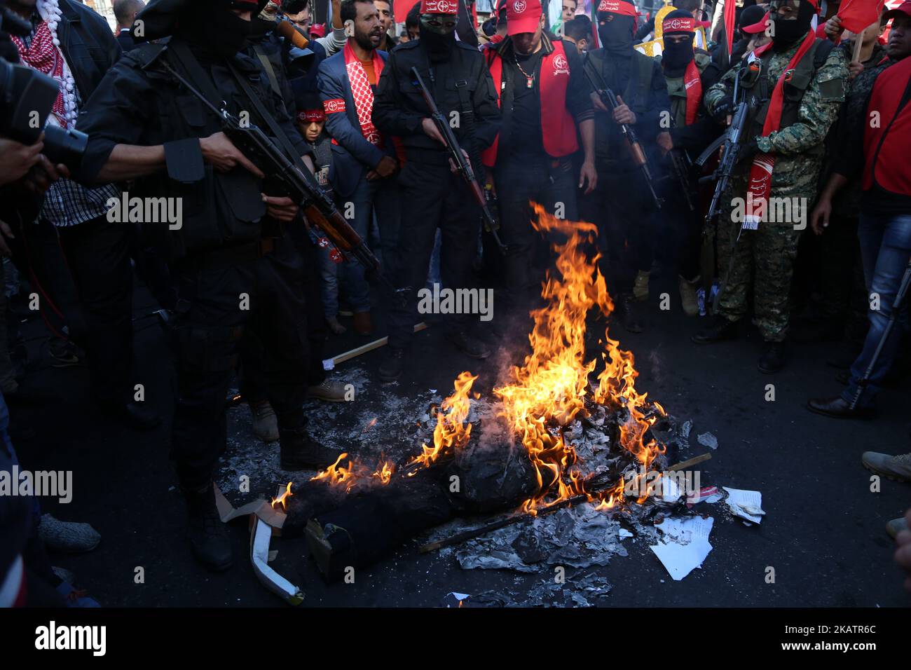 Palestinian militants of the Popular Front for the Liberation of Palestine (PFLP) burn representations of an Israeli flag and a U.S. flag during a protest against Trump's decision to recognize Jerusalem as the capital of Israel, in Gaza City December 9, 2017. (Photo by Majdi Fathi/NurPhoto) Stock Photo
