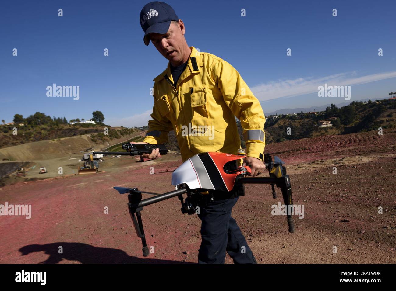Firefighter and remote drone pilot, David Danielson, retrieves a drone