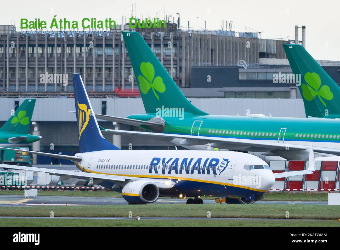 A Ryanair plane on the runway at Dublin airport passes near Aer Lingus planes. Passengers are facing severe travel disruption after Ryanair pilots in Ireland, Portugal, Germany, Italy and Spain has announced that they would be striking on Wednesday 20 December. Ryanair will publish contingency plans on next week’s planned strikes on its website. On Thursday, 14 December 2017, in Dublin, Ireland. (Photo by Artur Widak/NurPhoto)  Stock Photo