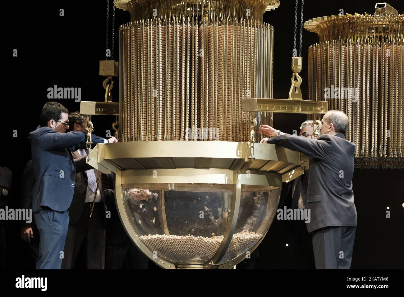 An official fills a drum with ball bearings of the lottery prizes during the draw of Spain's Christmas lottery named 'El Gordo' (Fat One) at the Teatro Real on December 22, 2017 in Madrid, Spain. The winning number wins a total of 4 million euros for the top prize to be shared between ten ticket holders. (Photo by Oscar Gonzalez/NurPhoto) Stock Photo