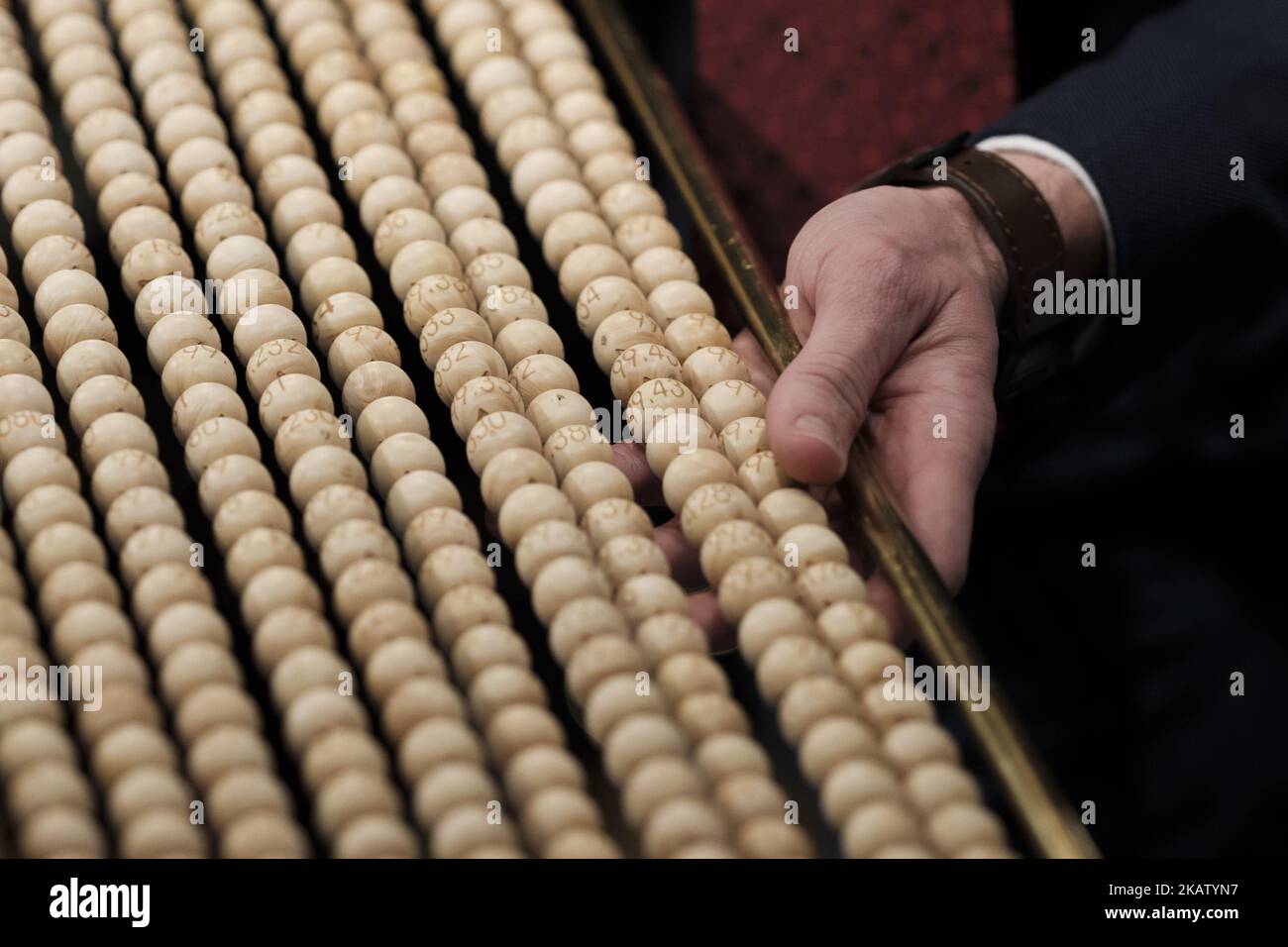 Officials check a ball bearing with the lottery ticket number of an spectator during the draw of Spain's Christmas lottery named 'El Gordo' (Fat One) at the Teatro Real on December 22, 2017 in Madrid, Spain. The winning number wins a total of 4 million euros for the top prize to be shared between ten ticket holders (Photo by Oscar Gonzalez/NurPhoto) Stock Photo