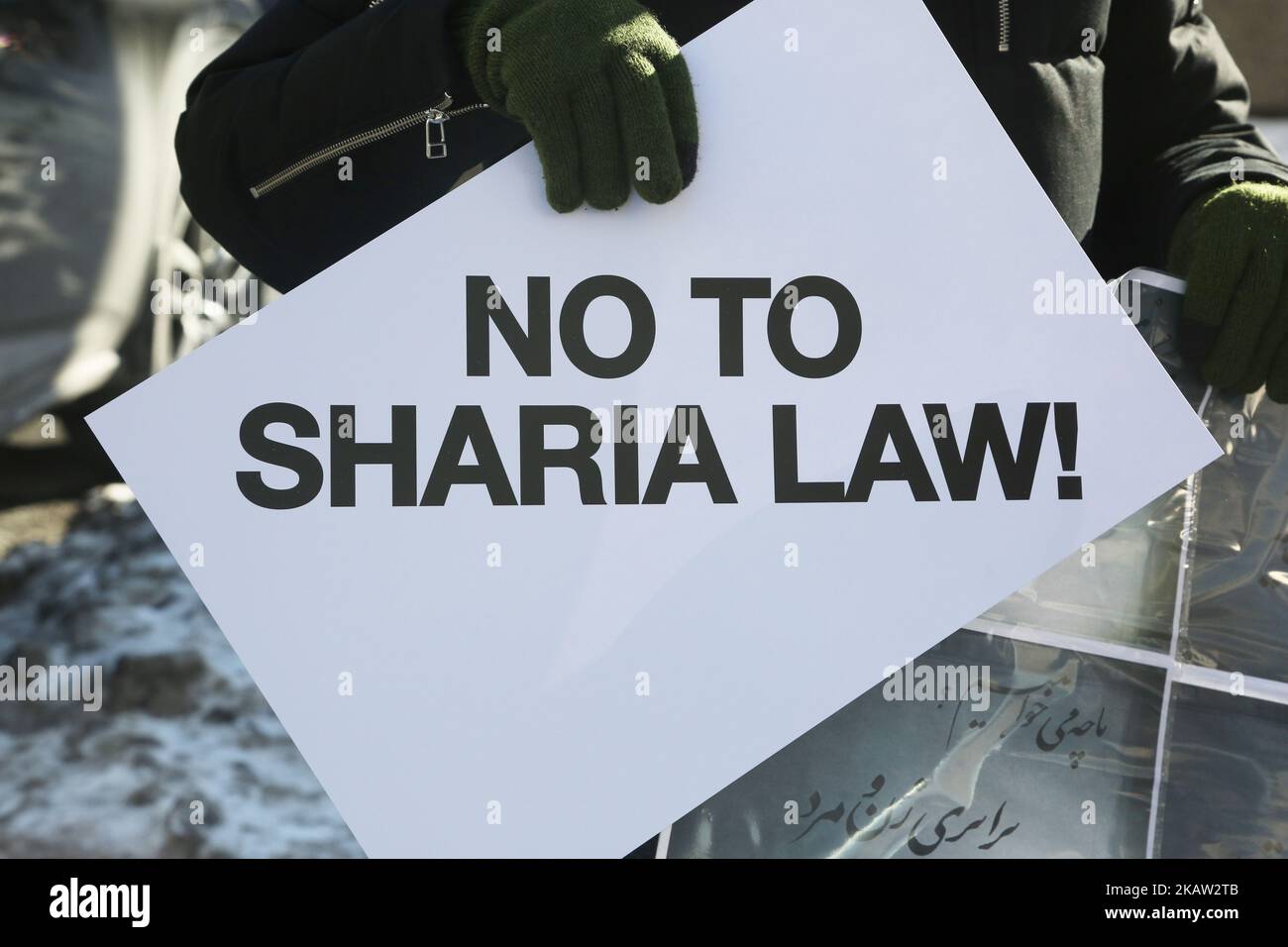 Protestor holds a sign saying 'No to Sharia law' as hundreds of Canadians take part in a protest against the Islamic Republic of Iran in Toronto, Ontario, Canada, on January 06, 2018. Protestors showed their solidarity with anti-government demonstrators in Iran and their support of a national uprising of the Iranian people. Protesters called for a regime change for social justice and freedom and democracy in Iran. There was a also a call that power in Iran be returned to Reza Pahlavi, the former Crown Prince of Iran and the last heir apparent to the defunct throne of the Imperial State of Iran Stock Photo