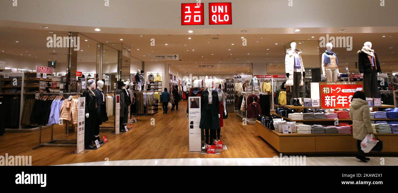Shoppers walk inside Fast Retailing's Uniqlo casual clothing store in