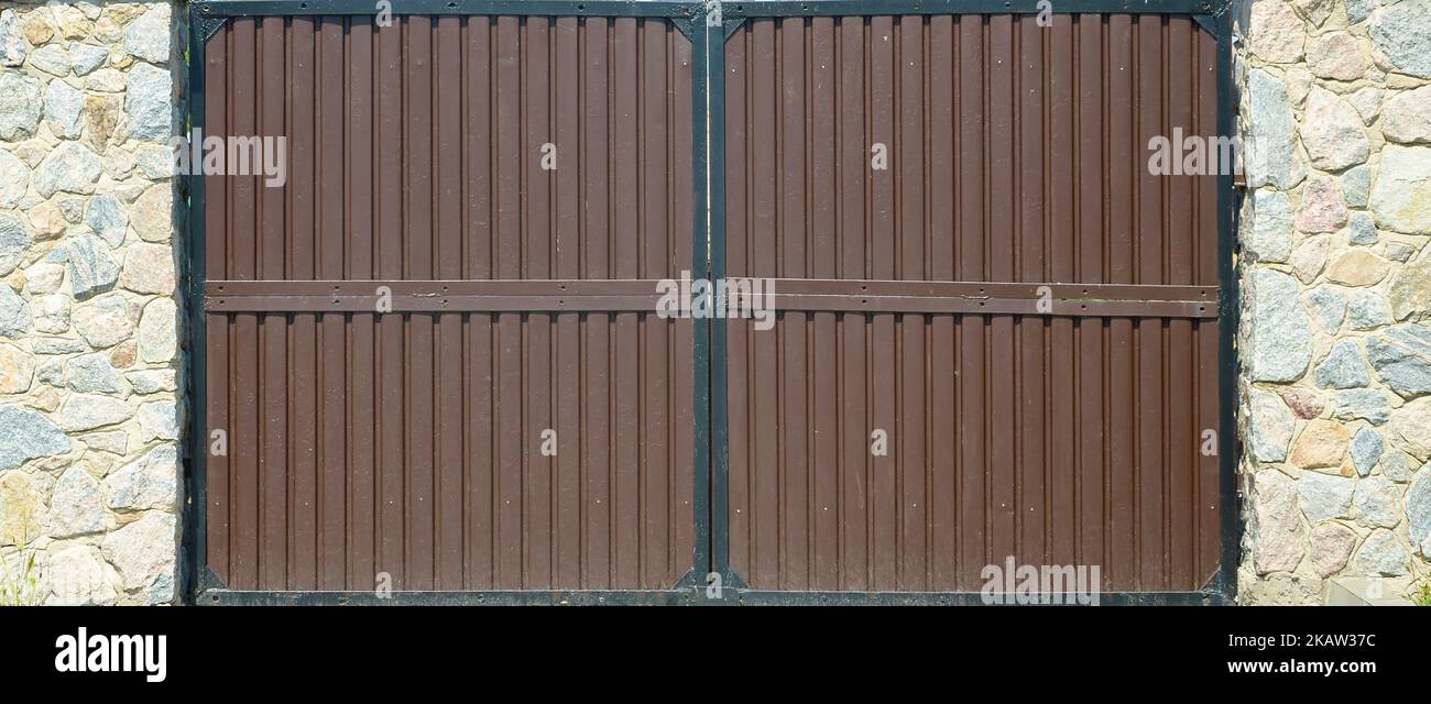 Dark brown metal Gates texture for transport entrance. Detailed texture of security gate to private area Stock Photo