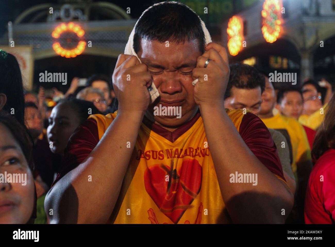 Devotees break into tears after the image of the Black Nazarene was successfully brought back inside the Quiapo Church in Manila, early morning of 10 January 2017. The feast of the Black Nazarene is held every 9th of January that attracts a massive crowd of mostly barefoot attendees as part of their sacrifice. The procession this year took 22 hours to finish. (Photo by George Calvelo/NurPhoto) Stock Photo