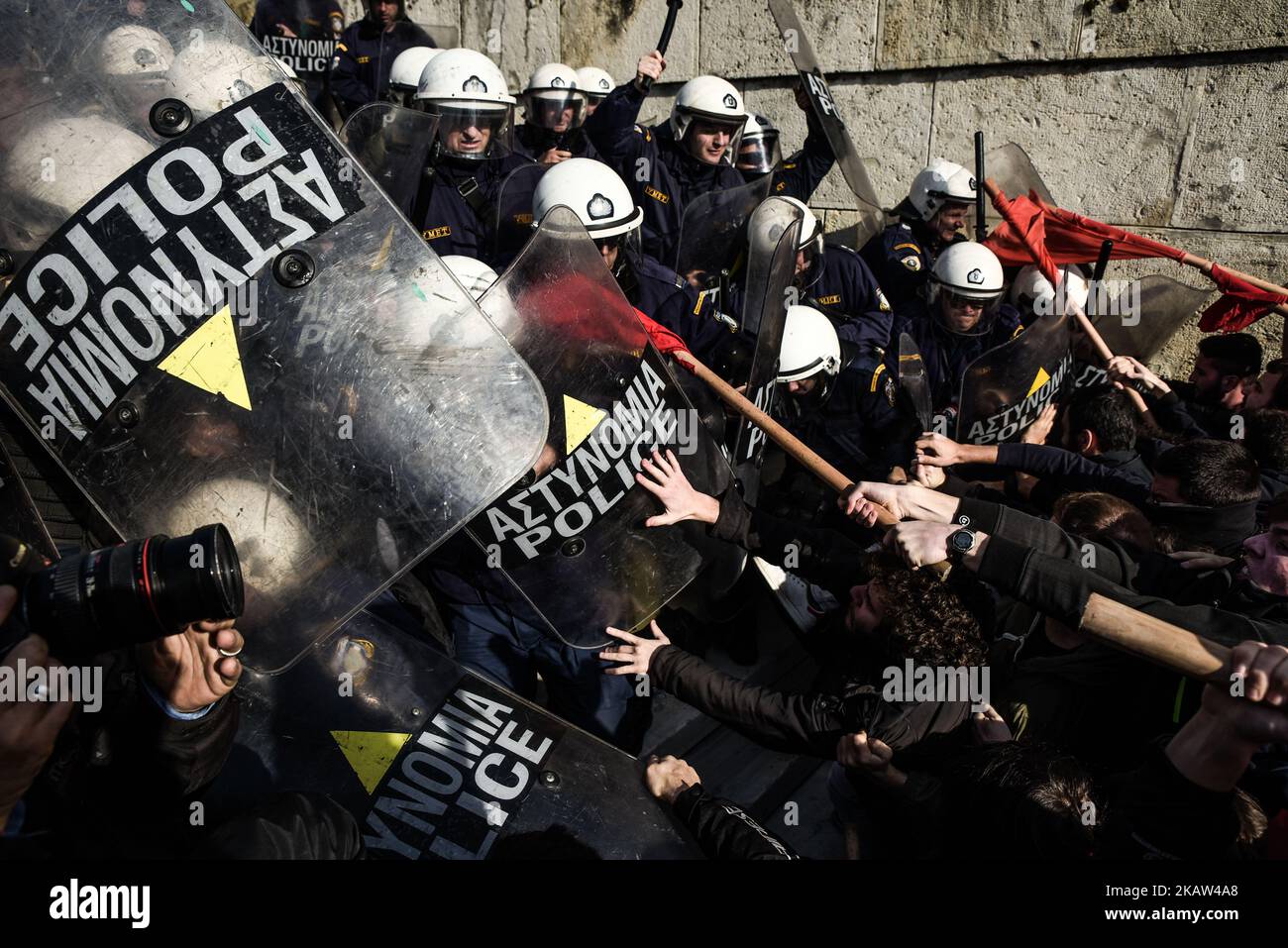 Protesters clash with police after the end of a protest against new reforms planned by the government concerning property auctions and labor strikes, outside parliament, in central Athens, Greece, 12 January 2018 Thousands of Greek protesters marched in central Athens on Friday against new reforms, including restrictions on the right to strike, that Parliament is set to approve next week in return for bailout funds. “Hands off strikes!” protesters with Communist-affiliated group PAME chanted during a march of about 20,000 people, as lawmakers debated in parliament. Others held banners reading  Stock Photo