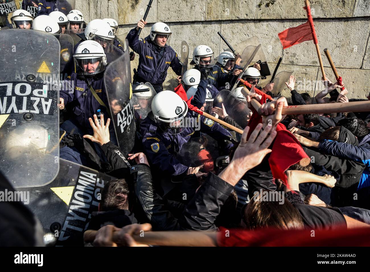 Protesters clash with police after the end of a protest against new reforms planned by the government concerning property auctions and labor strikes, outside parliament, in central Athens, Greece, 12 January 2018 Thousands of Greek protesters marched in central Athens on Friday against new reforms, including restrictions on the right to strike, that Parliament is set to approve next week in return for bailout funds. “Hands off strikes!” protesters with Communist-affiliated group PAME chanted during a march of about 20,000 people, as lawmakers debated in parliament. Others held banners reading  Stock Photo