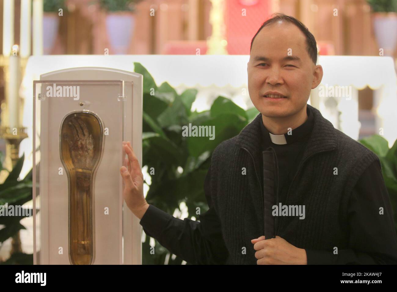 Father Francis Cheng venerates the forearm of Saint Francis Xavier, a